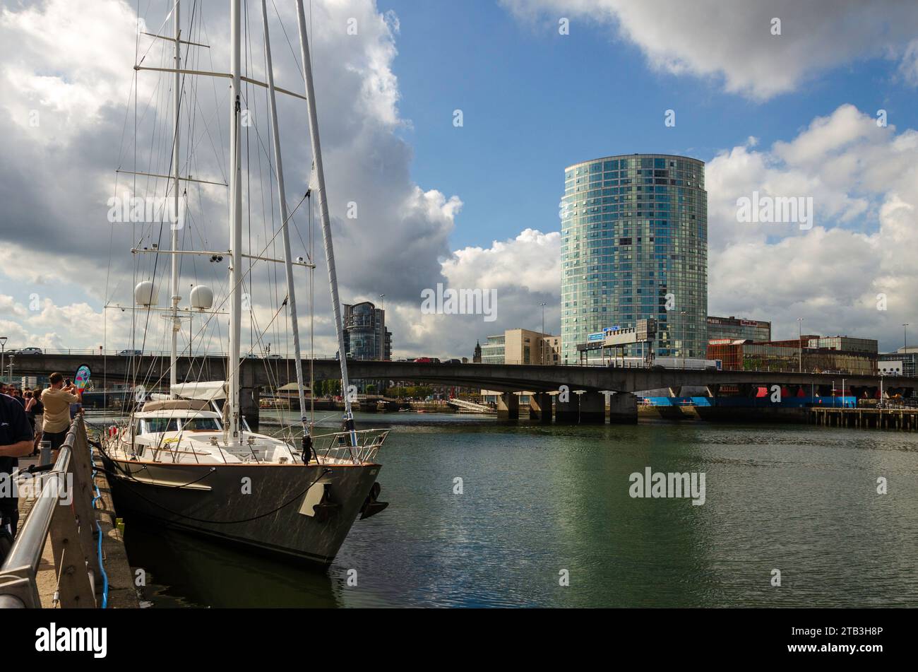 Belfast, County Antrim, Northern Ireland September 09 2023 - People taking photos of a yacht tied up at the Titanic dock with the Obel Tower block in t Stock Photo