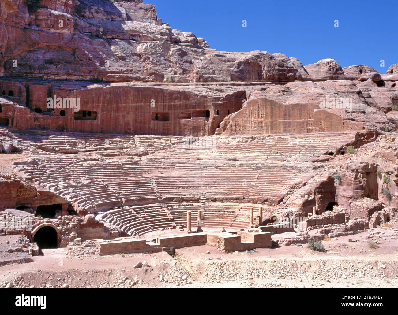 The Nabatean amphitheatre in the ancient city of Petra, Jordan. Theatre with row of seats and stairways carved into the side of the mountain. Stock Photo
