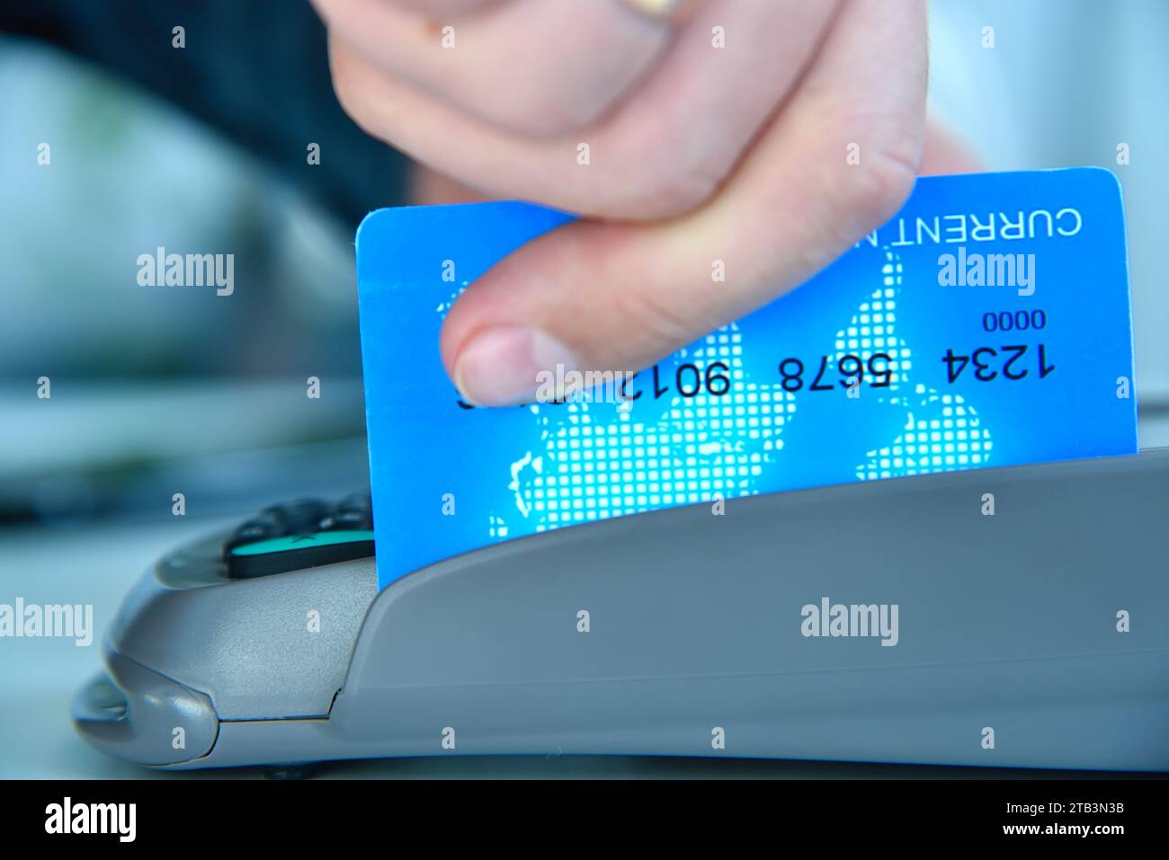 Pay money blue credit card for spending money with payment terminal. Transaction pay and shopping concept.  Close Up Stock Photo