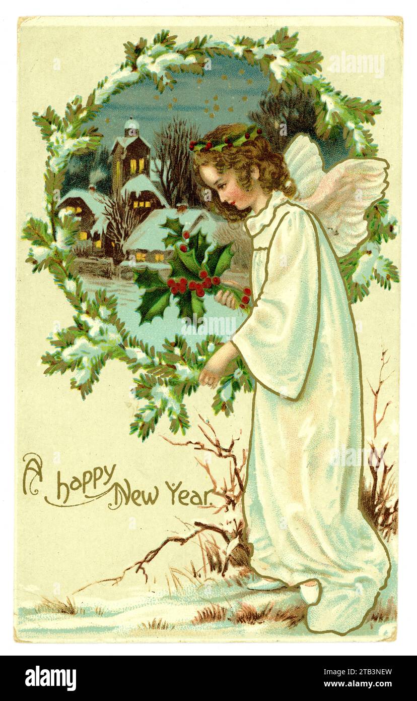 Original Edwardian era Happy New Year greetings card of an angel with a bough of holly and a church in the background in a winter landscape. circa 1905, 1910. U.K. Stock Photo