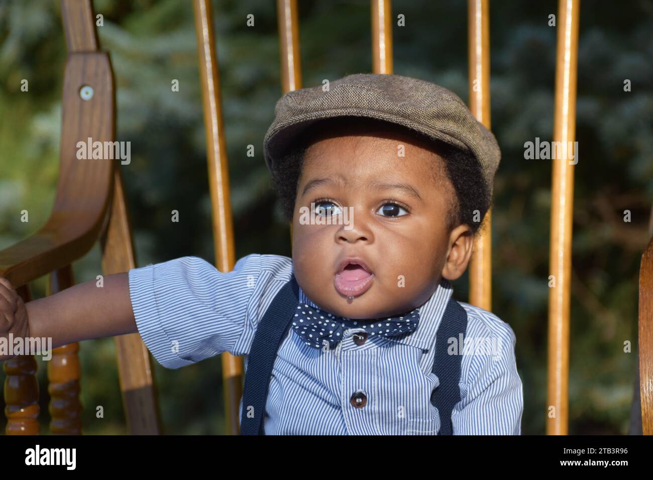 Adorable Cute baby boy in hat, drooling, black baby boy Stock Photo