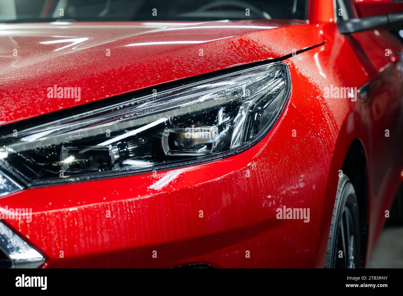 Closeup of a red car headlight with vinyl wrap Stock Photo Alamy