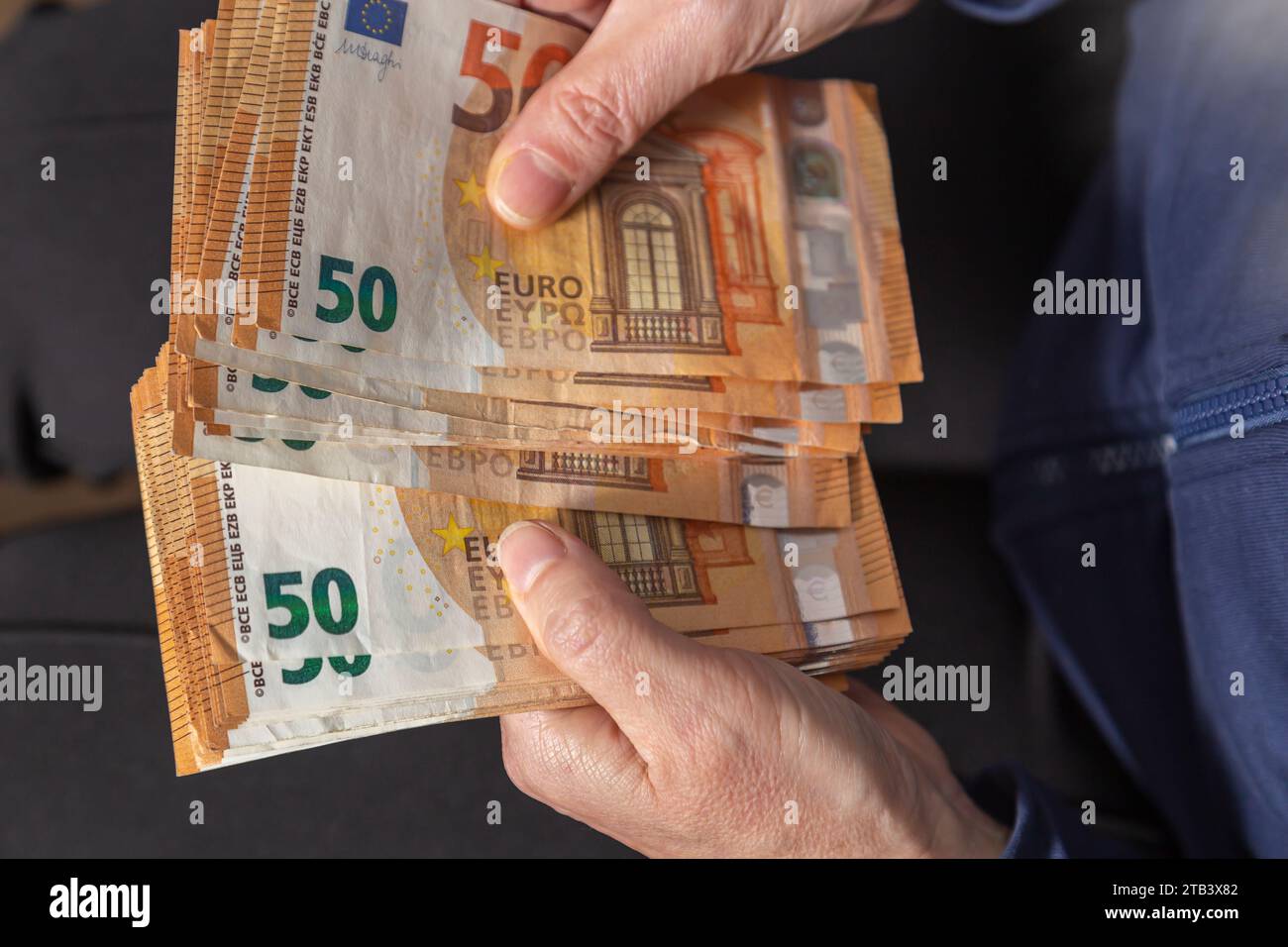 Woman hands is counting fifty euros banknotes. View from above. Closeup. Stock Photo
