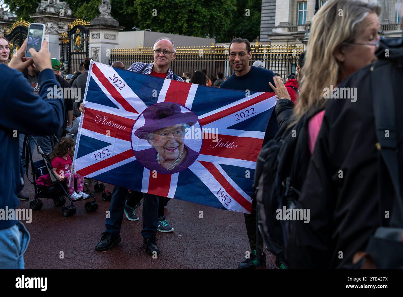 A man holding a Union Jack flag with the portrit of Queen Elizabeth II a day after her passing Stock Photo