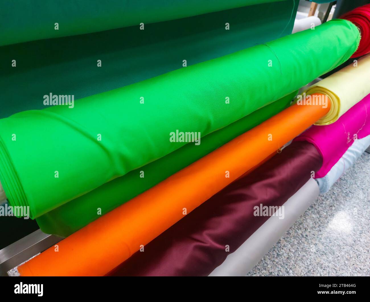 shelves with many rolls of fabric for sale in haberdashery shop for