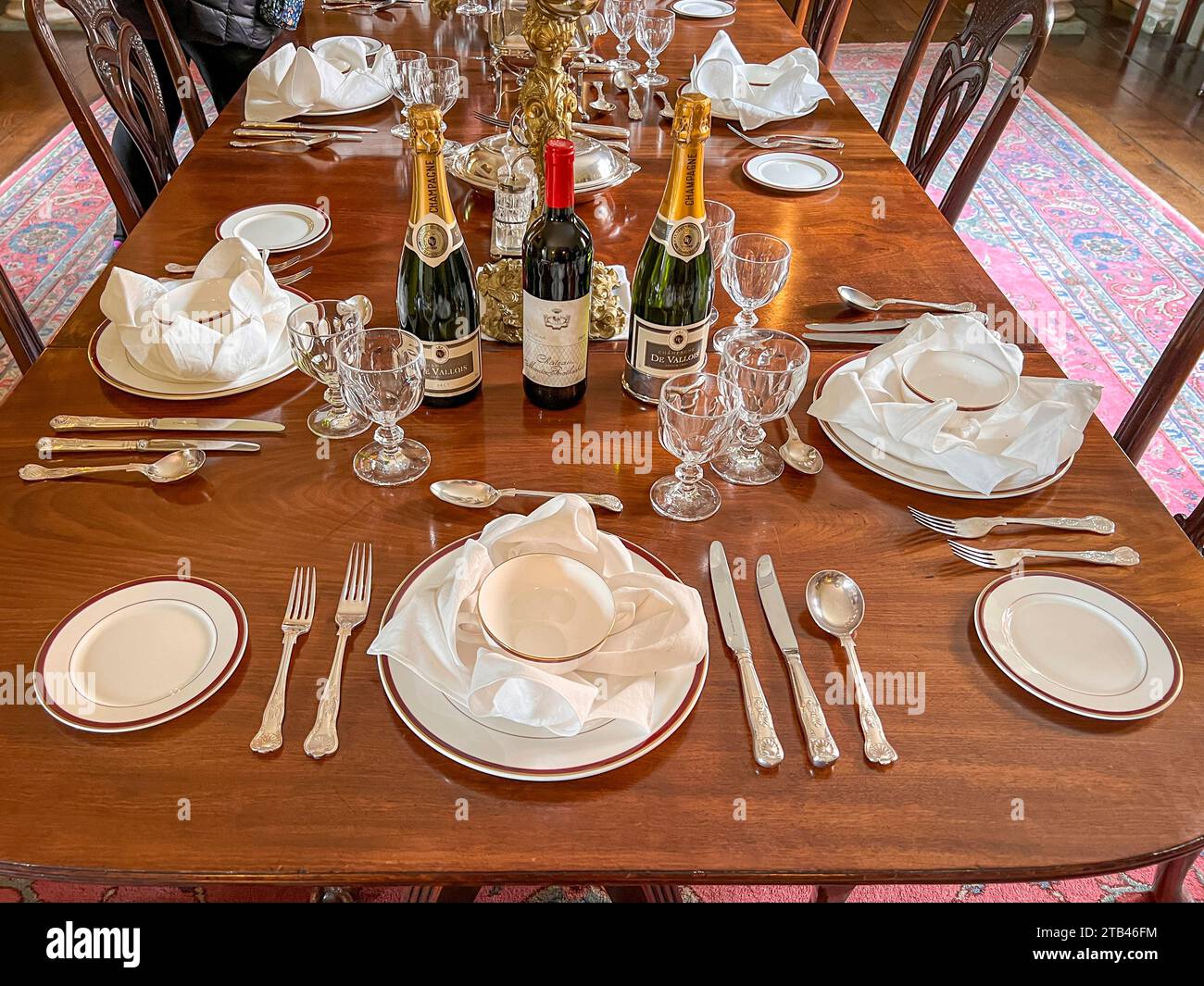 An antique dining table set for a dinner party Stock Photo - Alamy