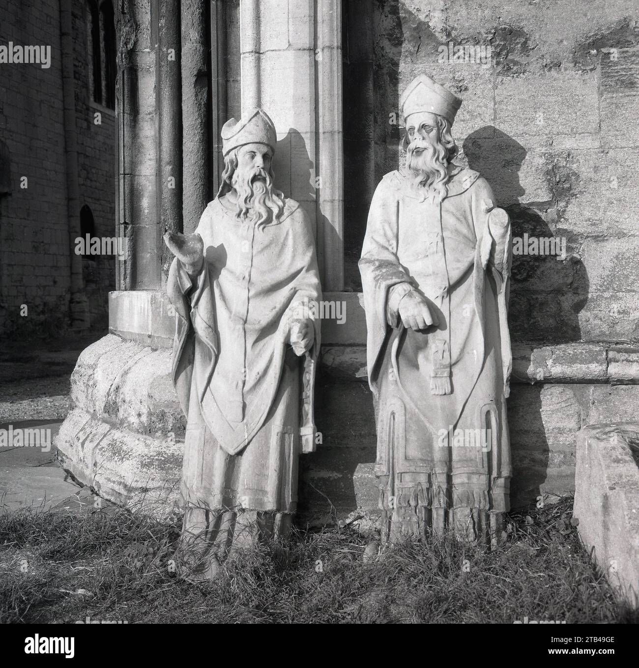 1960s, historical, two stone ecclesiastical bearded figures at the entrance to a church. Stock Photo