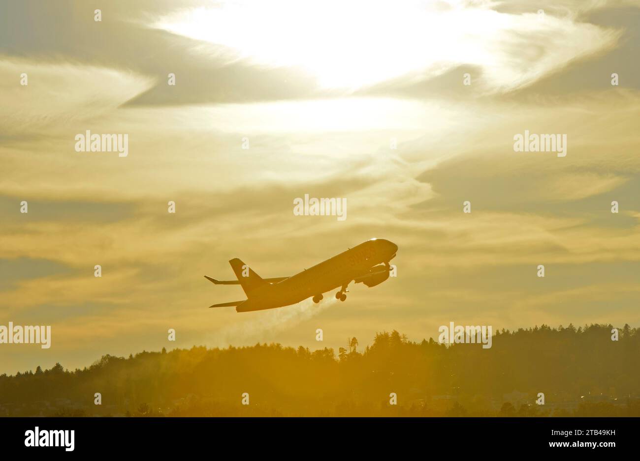Airbus of the airline Swiss International Air Lines after take-off in climbing departure against the light, Zurich Airport, Zurich, Switzerland Stock Photo