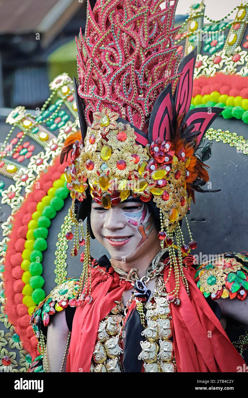 Boy in elaborate costume, annual International Flower Festival parade in Tomohon city, the centre of floriculture. Tomohon, North Sulawesi, Indonesia Stock Photo