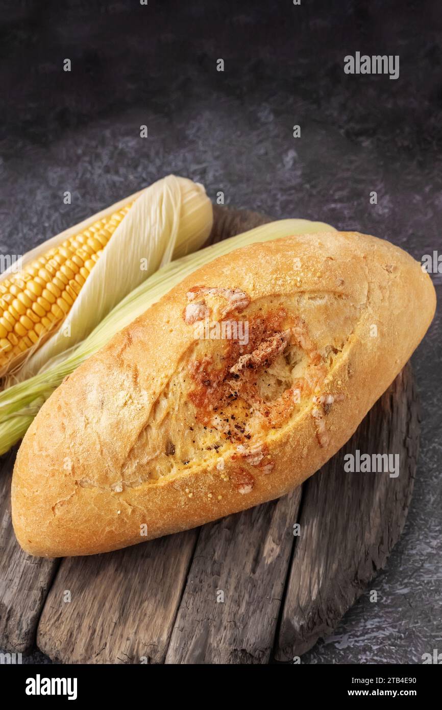Fresh cornbread and corn grains on the table. Food grain crisis concept. Close up, Copy space Stock Photo