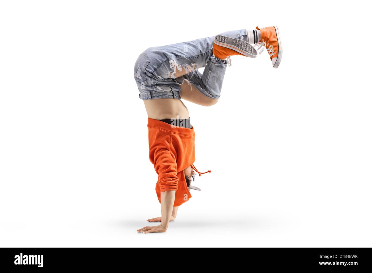 Female in jeans performing a hand stand isolated on white background Stock Photo