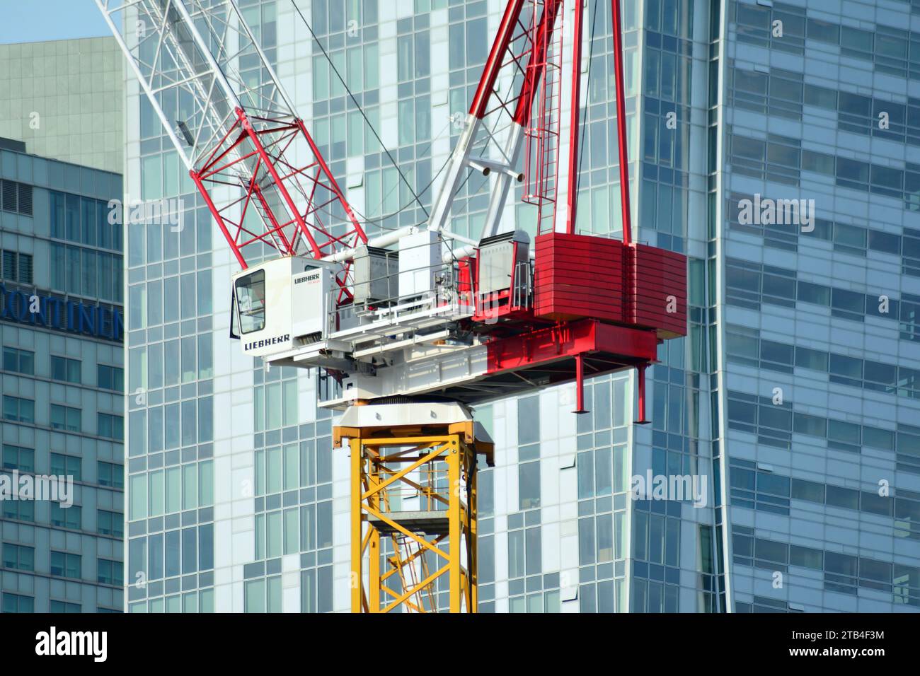 Image showcasing High rise building under construction. Installation of glass facade ...