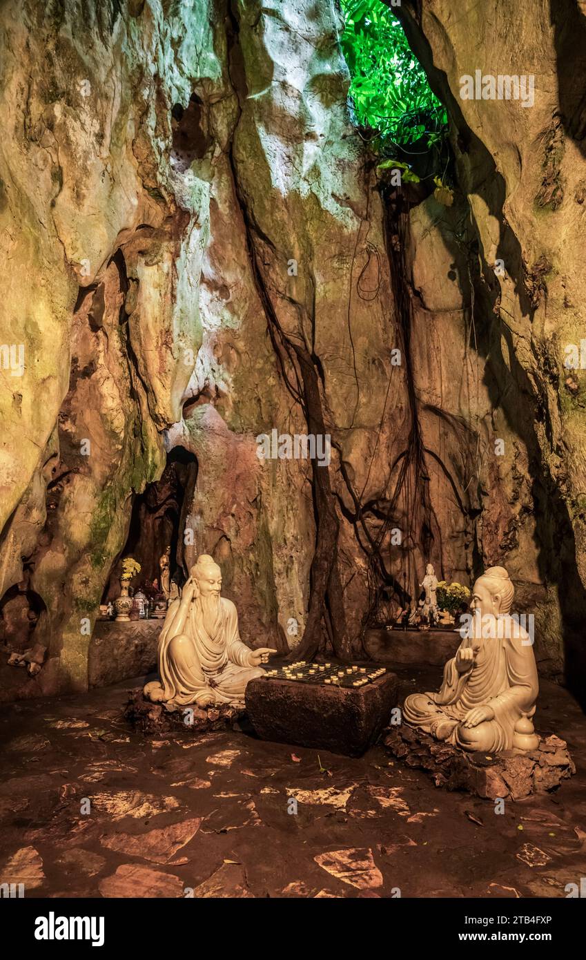 Sculpture of chess players in Ban Go Grotto inside Tang Chon Cave on the Marble Mountain in Vietnam Stock Photo