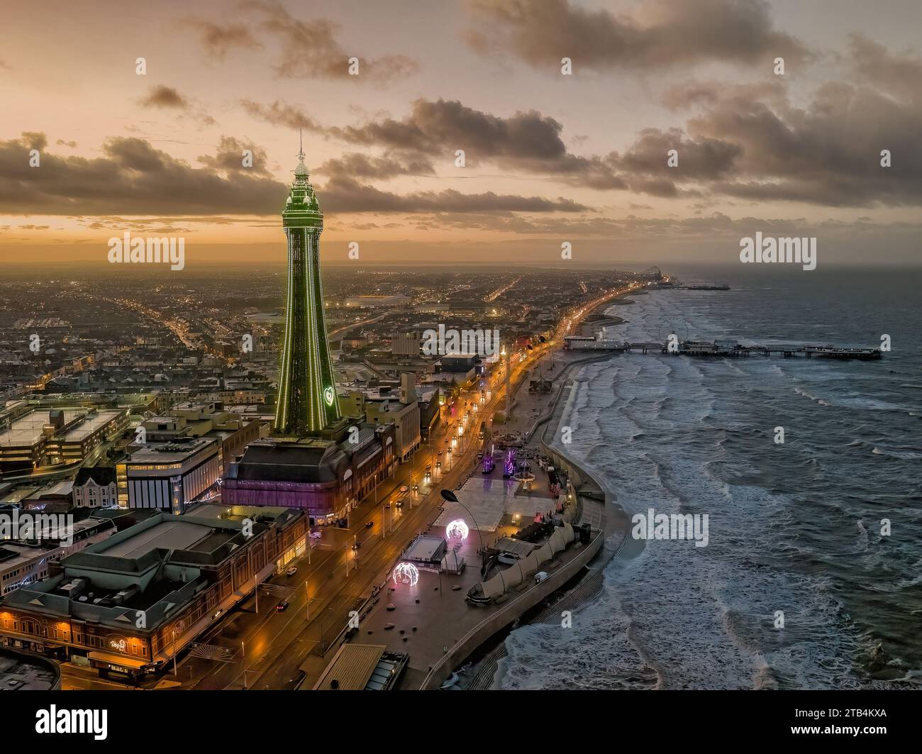 Blackpool, Lancashire, United Kingdom.Blackpool sea front and tower aerial view at dusk with illuminations looking towards the pier and pleasure beach Stock Photo