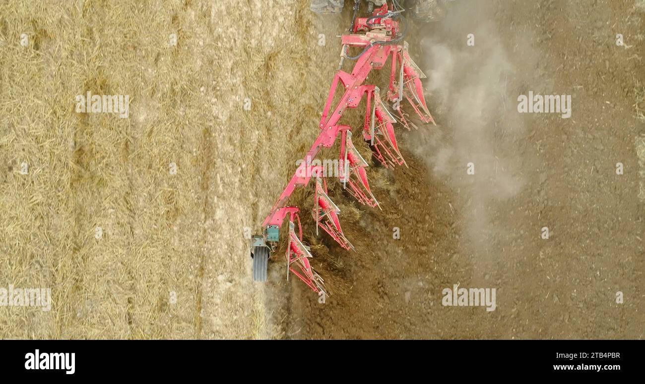 Tractor plowing field with harrows - 4K Stock Photo - Alamy