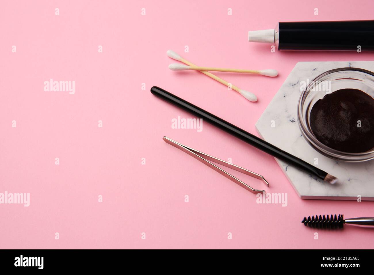 Eyebrow henna and tools on pink background. Space for text Stock Photo