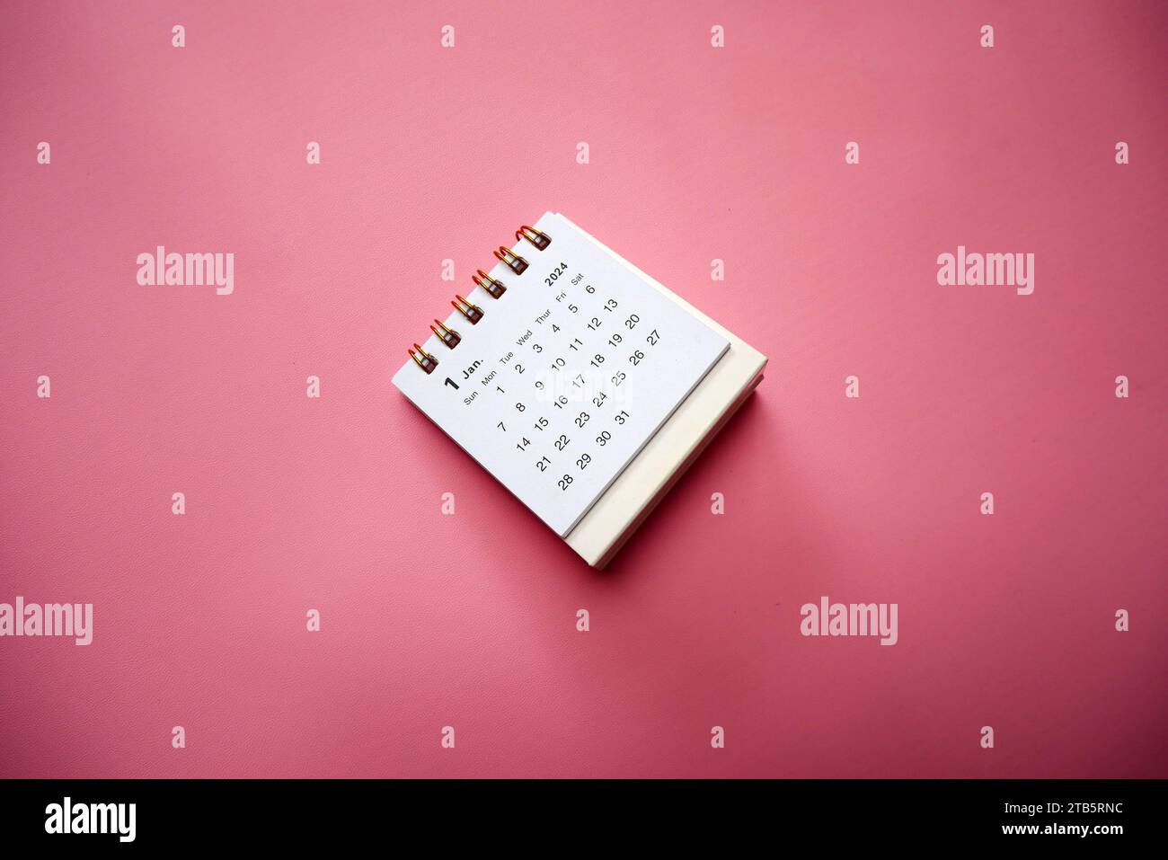 2024. January 2024 desk calendar isolated on pink background