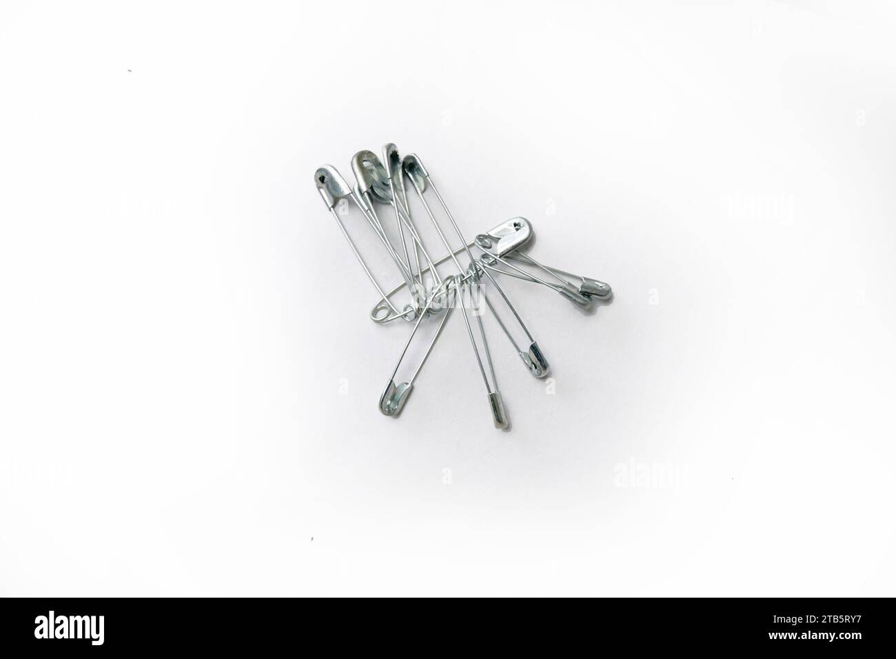 Safety pins isolated on a white background Stock Photo - Alamy