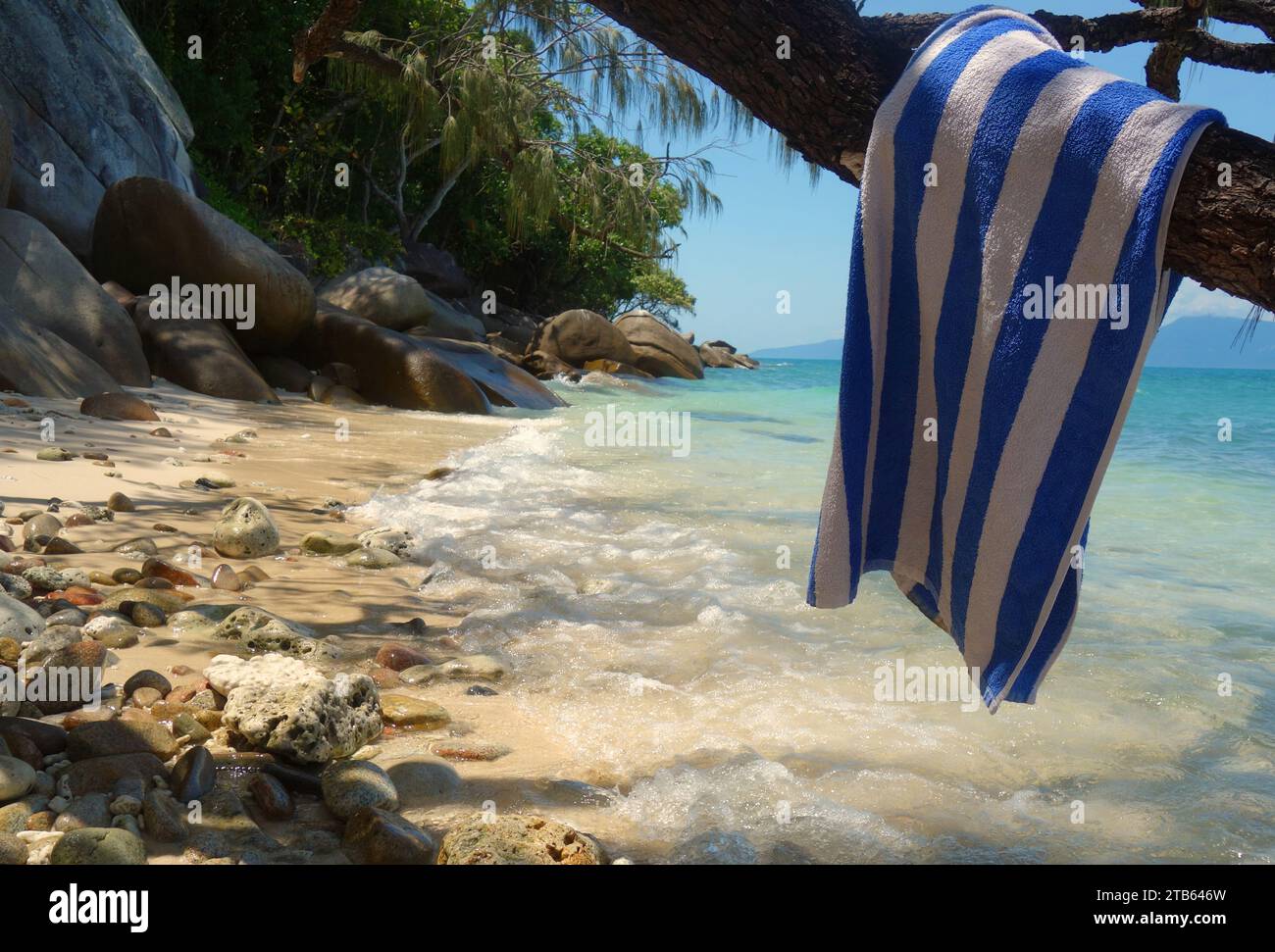 Remote beach with resort towel hanging on tree branch, Fitzroy Island, Queensland, Australia Stock Photo