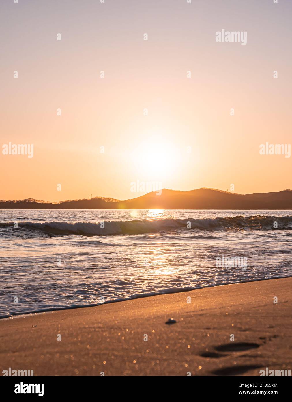Sunset on the beach. Orange and golden sunset sky calmness tranquil relaxing sunlight summer mood. Stock Photo