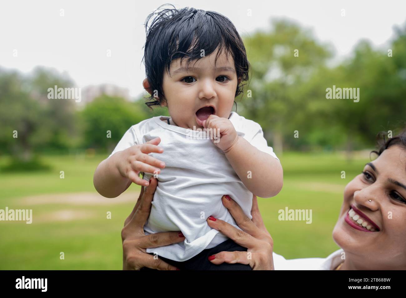 Portrait of happy cute indian kid or boy playing and having fun in outdoor park. Stock Photo