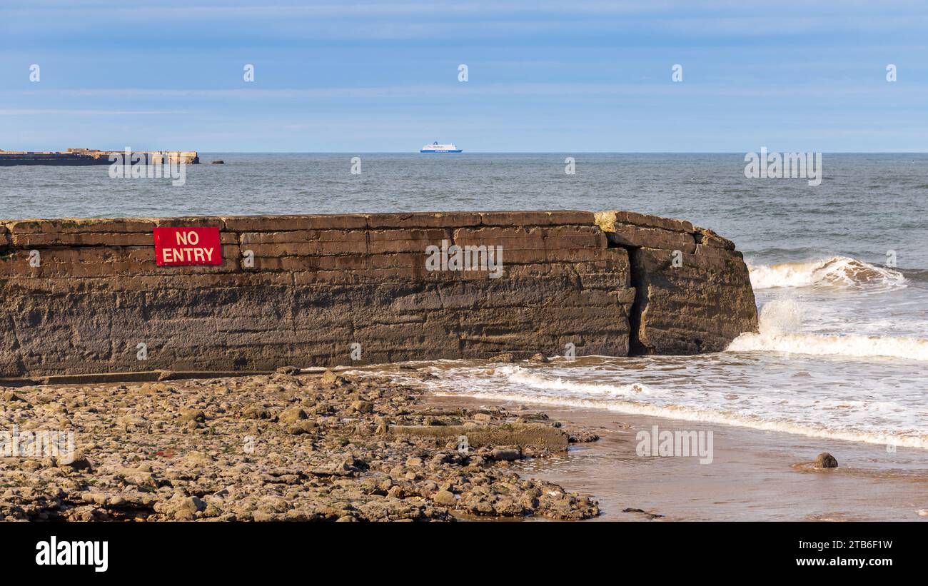 A breaking wall on Grangetown Beach, Tyne and Wear, England, UK Stock Photo