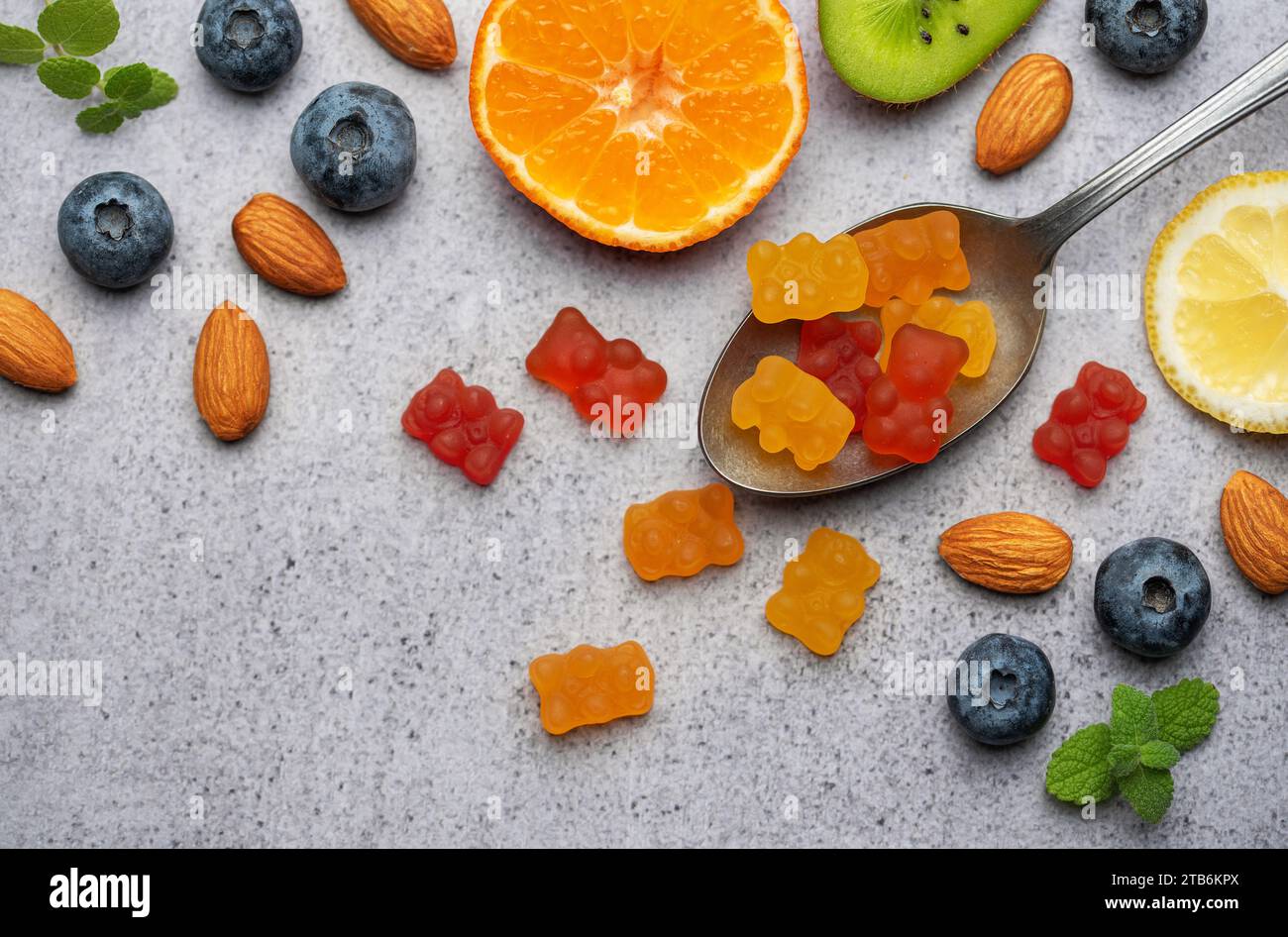 Chewable gummy bears vitamins and supplements and fresh fruits Stock