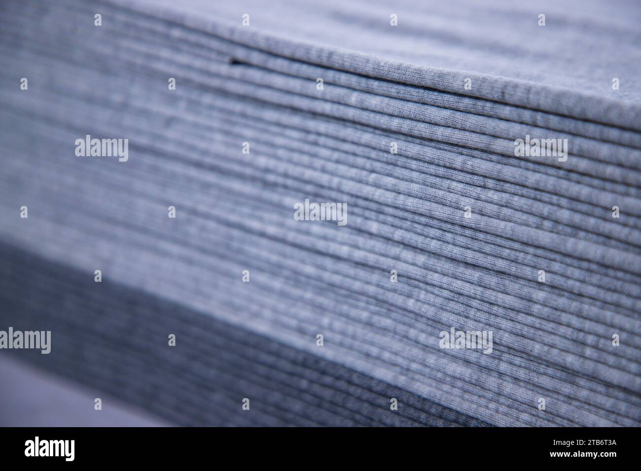 Stacked folded  Gray fabric Surface Texture Background Wallpaper. Selective Focus Stock Photo