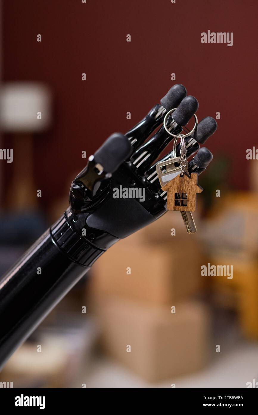 Vertical image of girl with prosthetic arm getting key from new house ...