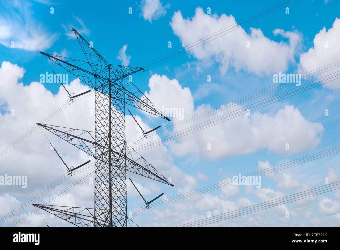 High voltage power lines tower with a blue sky background Stock Photo ...