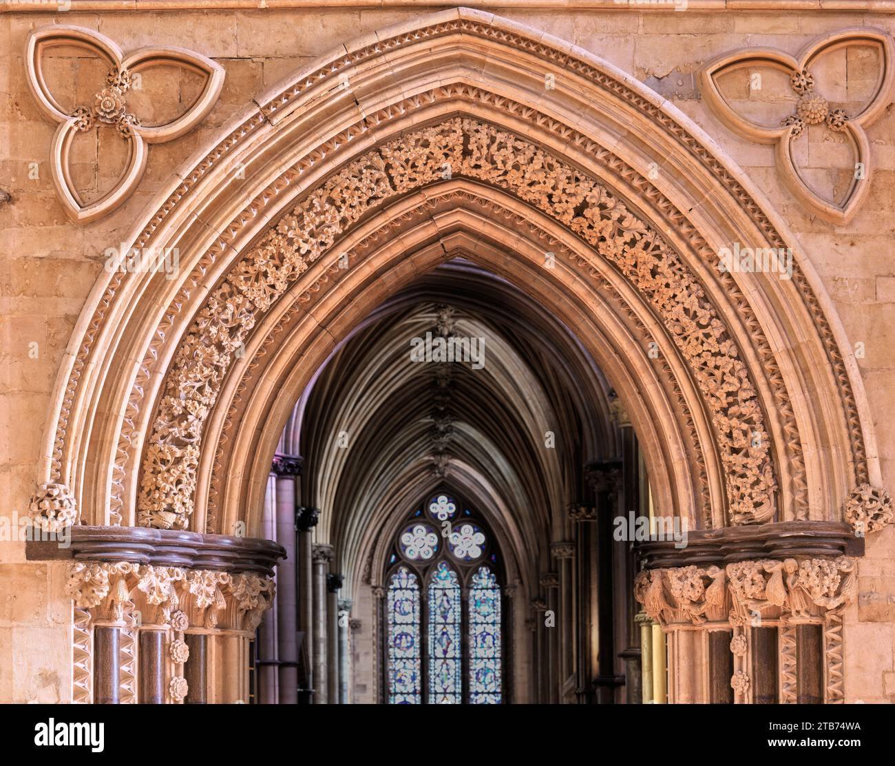 Elaborate arch on the north aisle over the transition from the nave to the chancel in the christian medieval cathedral at Lincoln, England. Stock Photo
