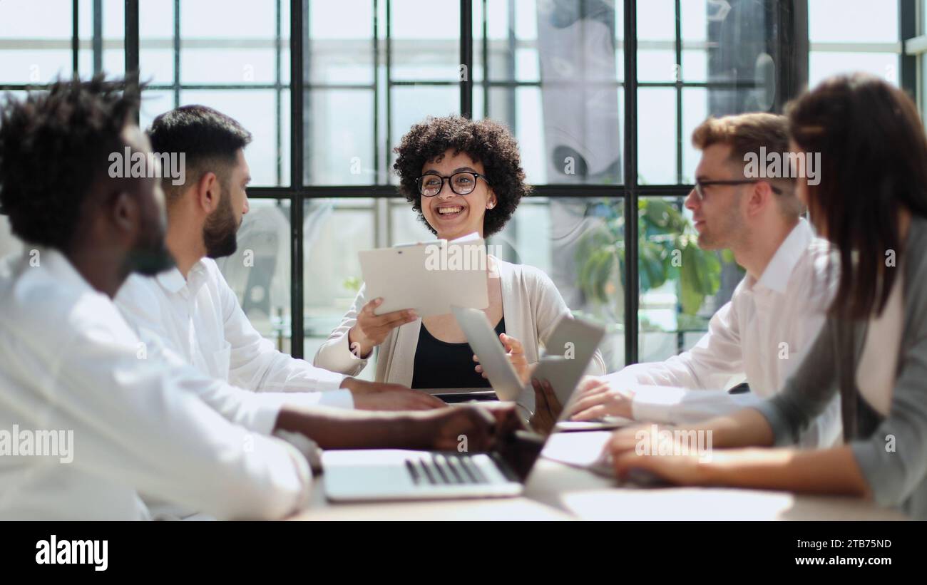 Employees working at computer together, discussing content Stock Photo ...