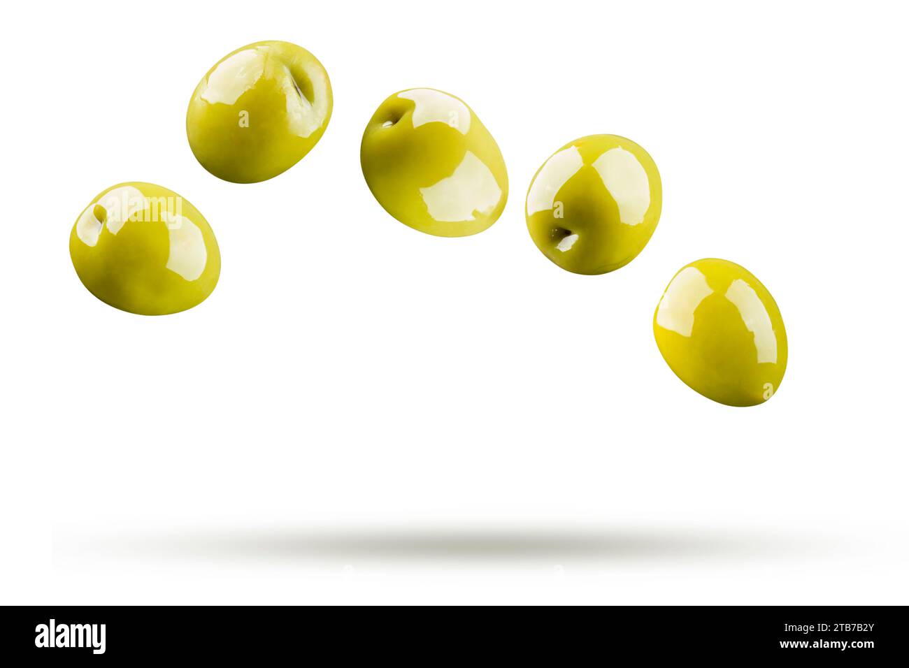 Green olives falling isolated on white background Stock Photo