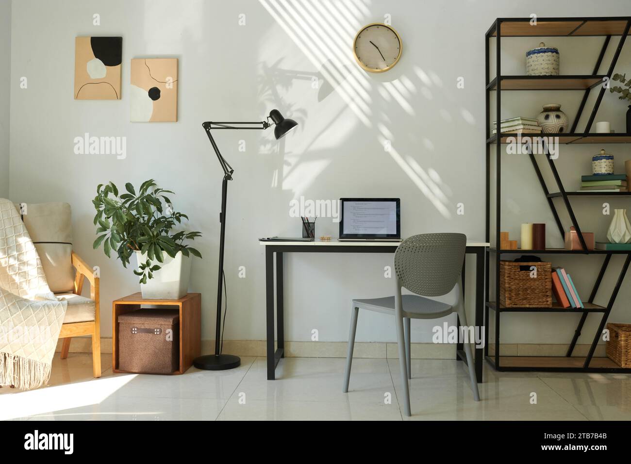 Laptop with programming code on screen on desk in home office of software developer Stock Photo