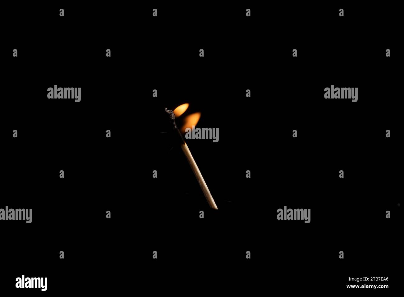 Lit and falling match on a black background. Stock Photo