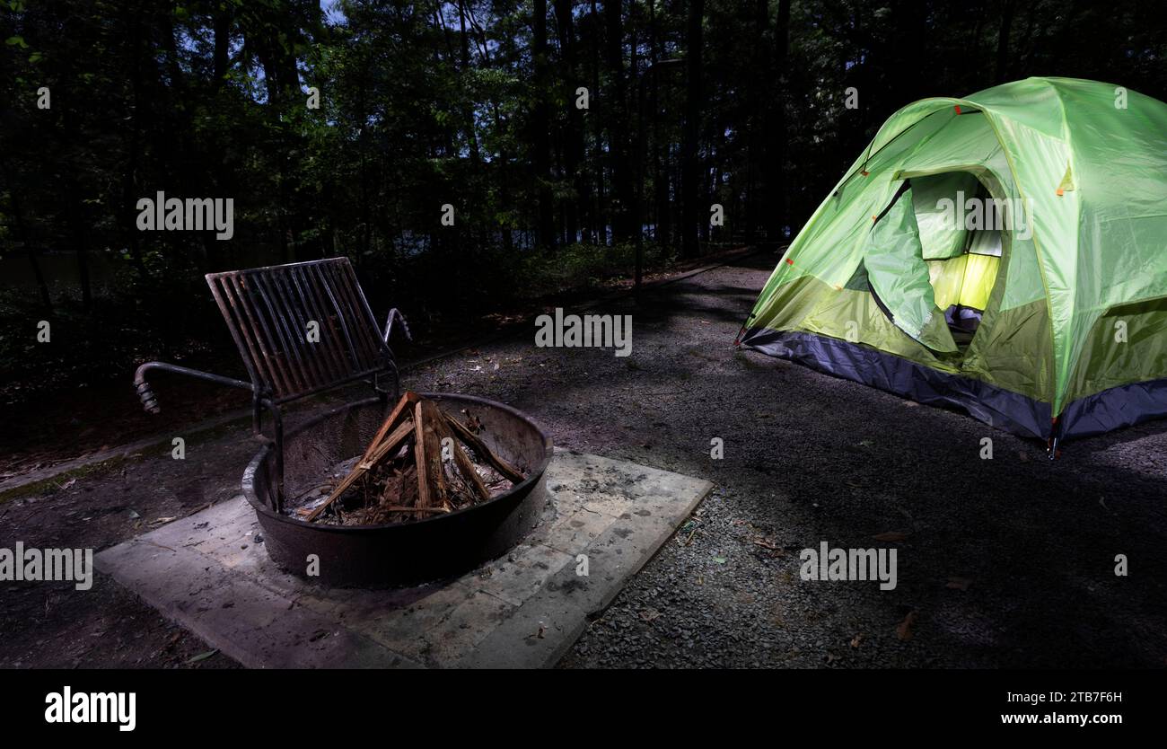 Sun fading over a shady campsite with a backpacking tent pitched and
