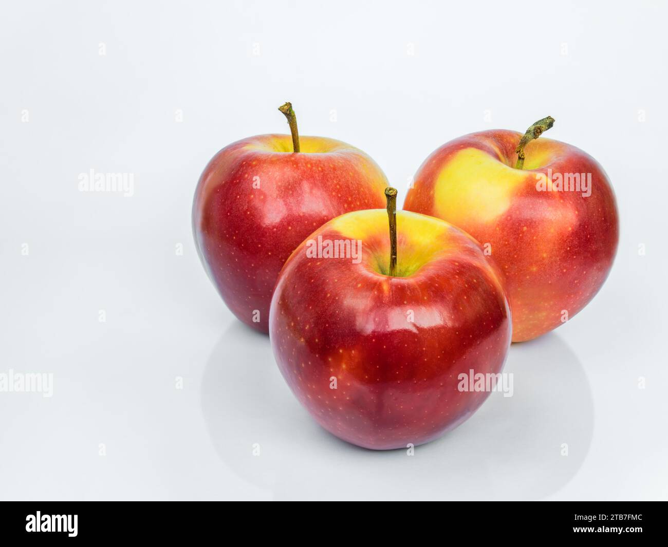 Three red ripe Gala apples isolated on a white background with reflection Stock Photo