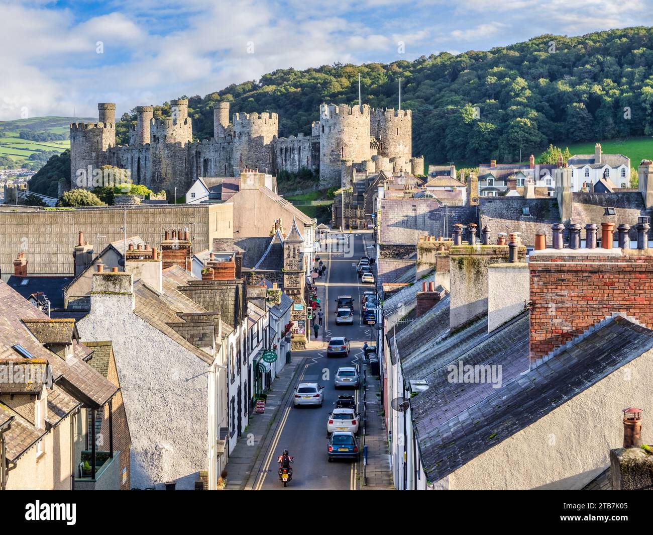 29 September 2023: Conwy, North Wales, UK - Conwy Castle and Barry Street, with traffic and people. Stock Photo