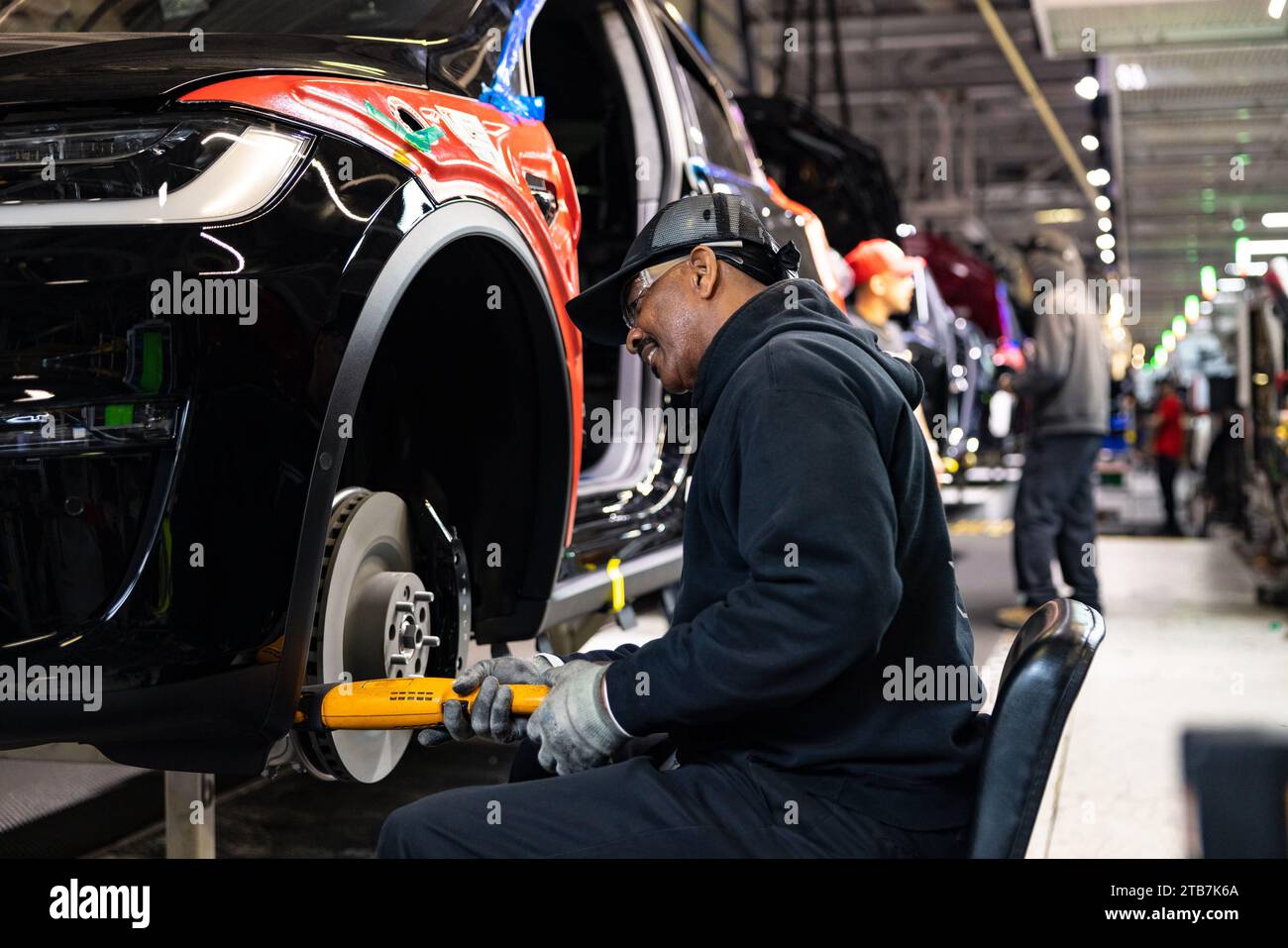 United States, California, Fremont: worker on the assembly line at the Tesla car factory. Courtesy of Tesla, Inc. Stock Photo