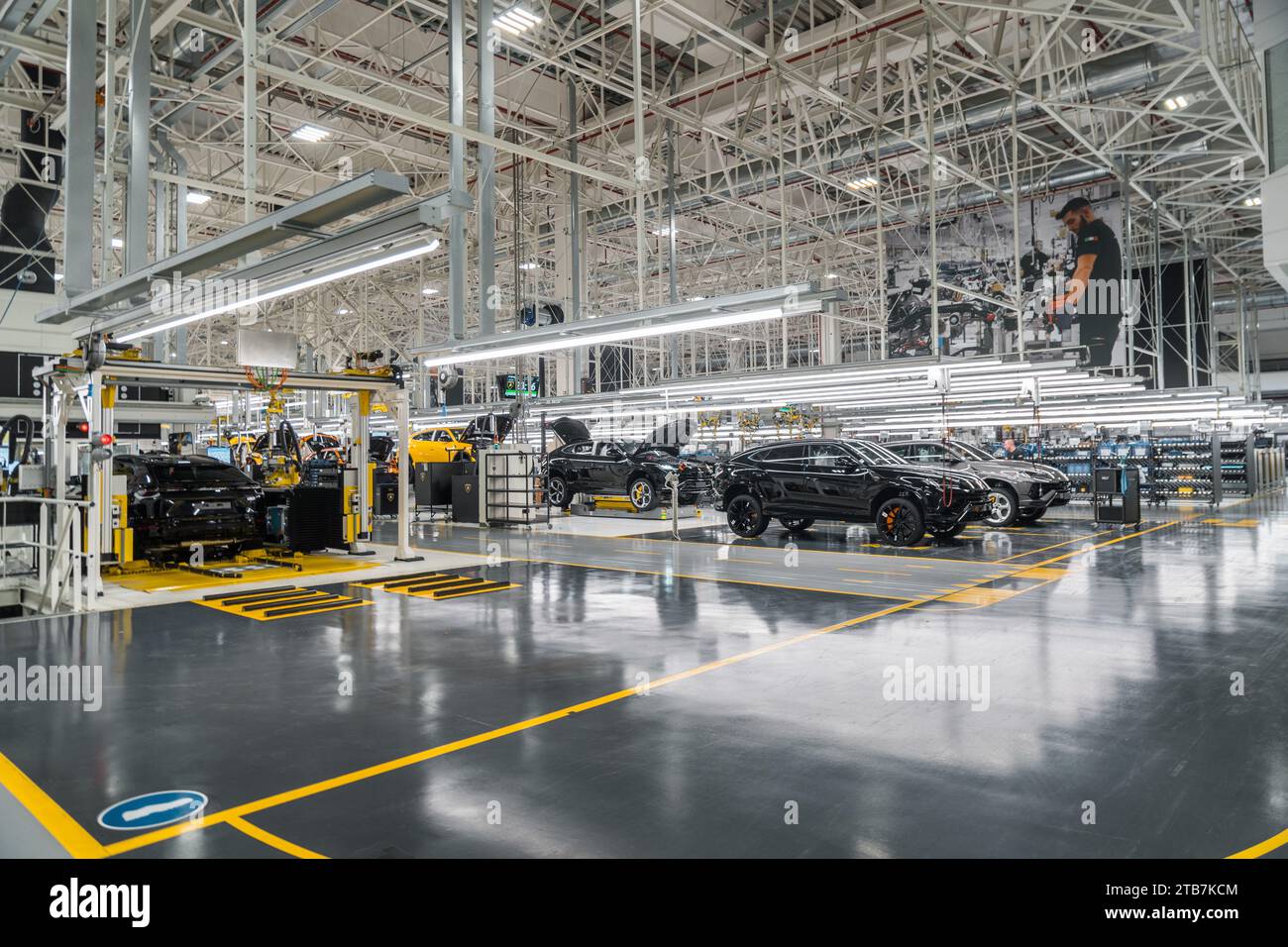 Italy, Sant’Agata Bolognese, Automobili Lamborghini’s plant, 2022/11/23: worker, viewed from behind, at work on a production line. Cabling Stock Photo
