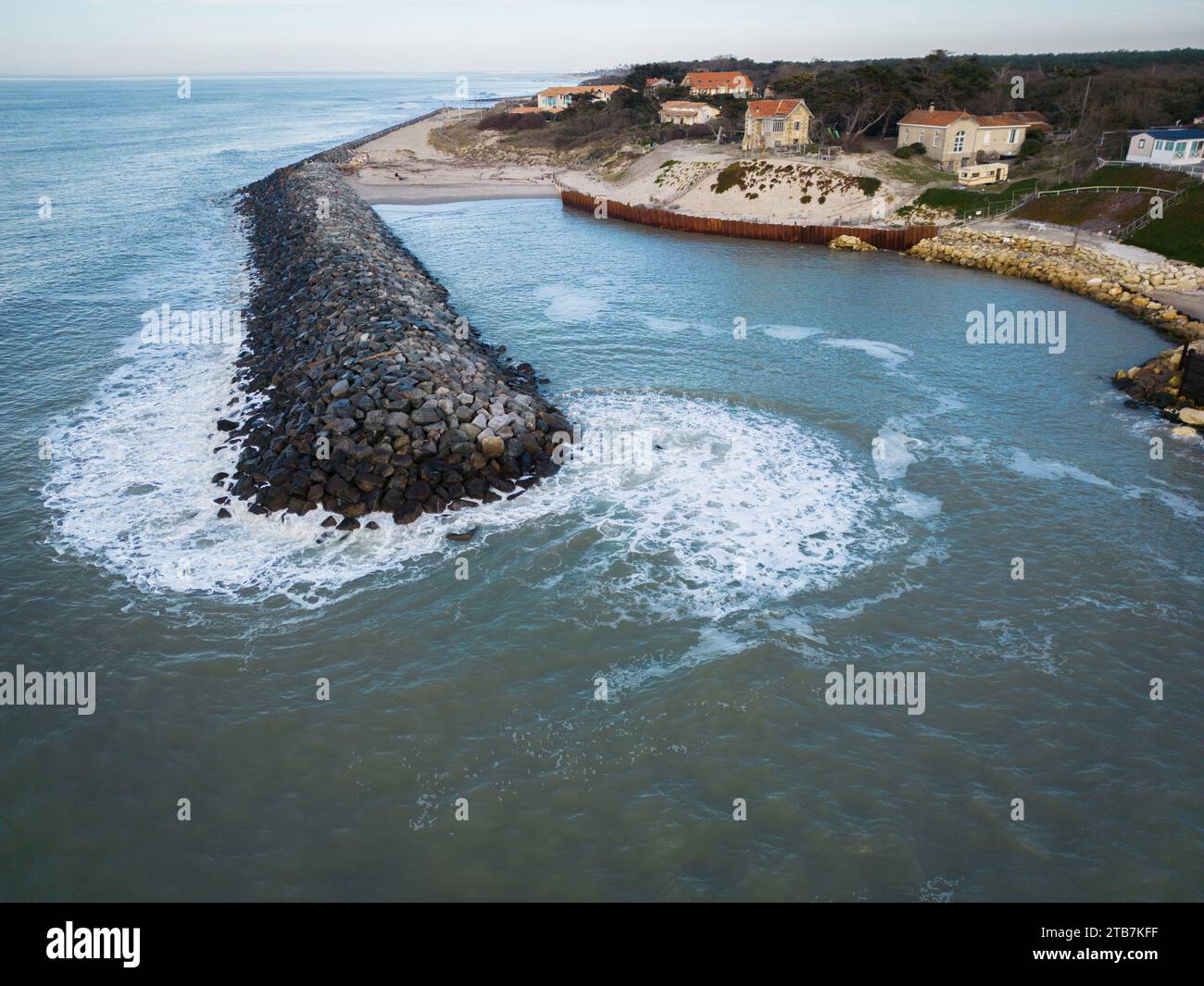 Soulac-sur-Mer (central-western France), February 20, 2023: coastal erosion control on the beach “plage de l’Amelie”. Riprap, rocky peaks, protective Stock Photo