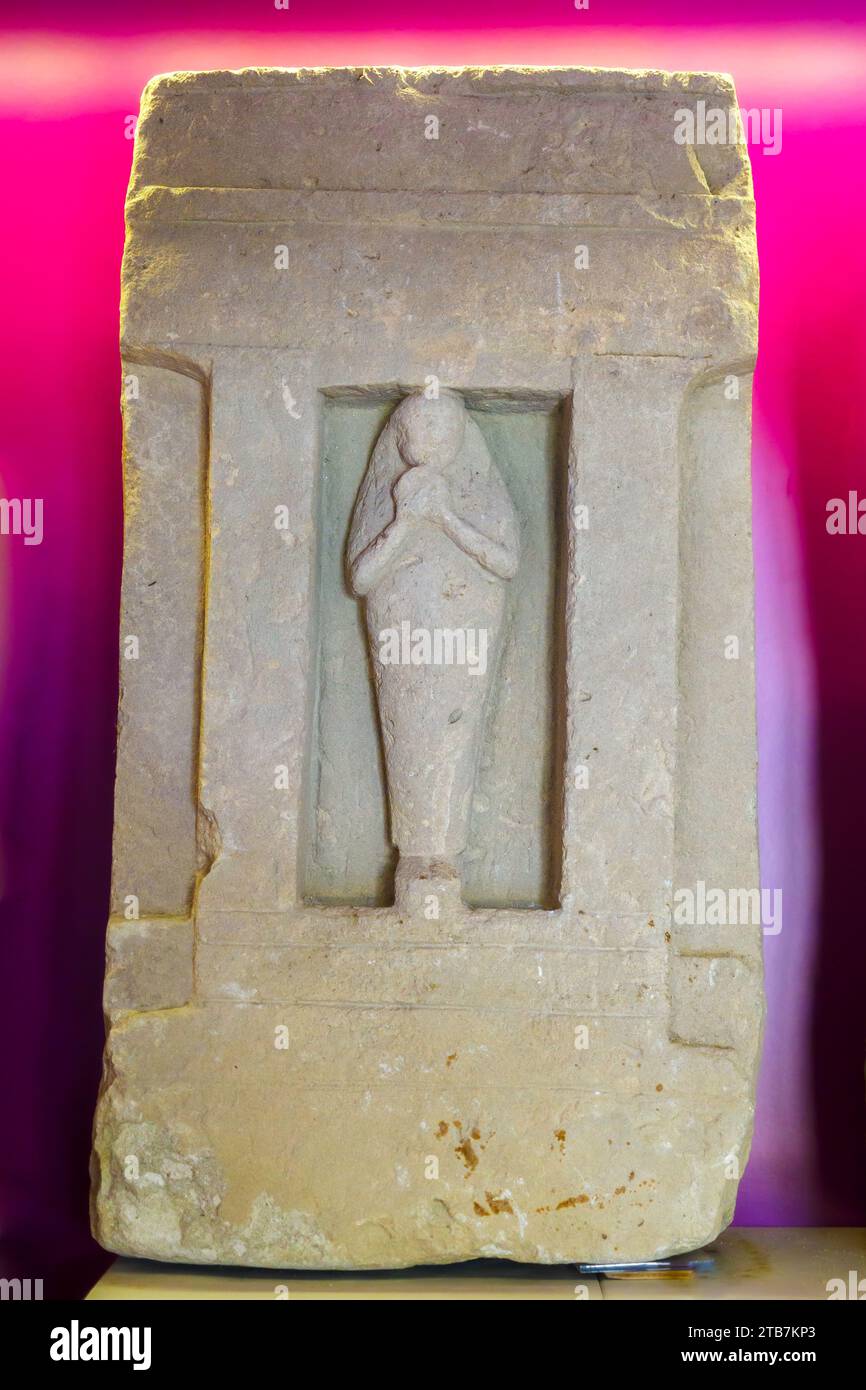 Stele showing a frontal female figurine with a tamburine,  5th century BC. - Baglio Anselmi archaeological museum - Marsala, Sicily, Italy Stock Photo