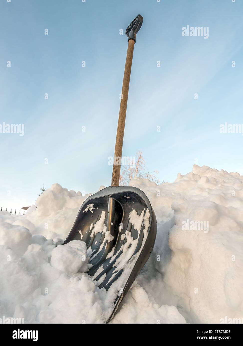 Shot of snow clearing shovel driven into thick snow cover Stock Photo