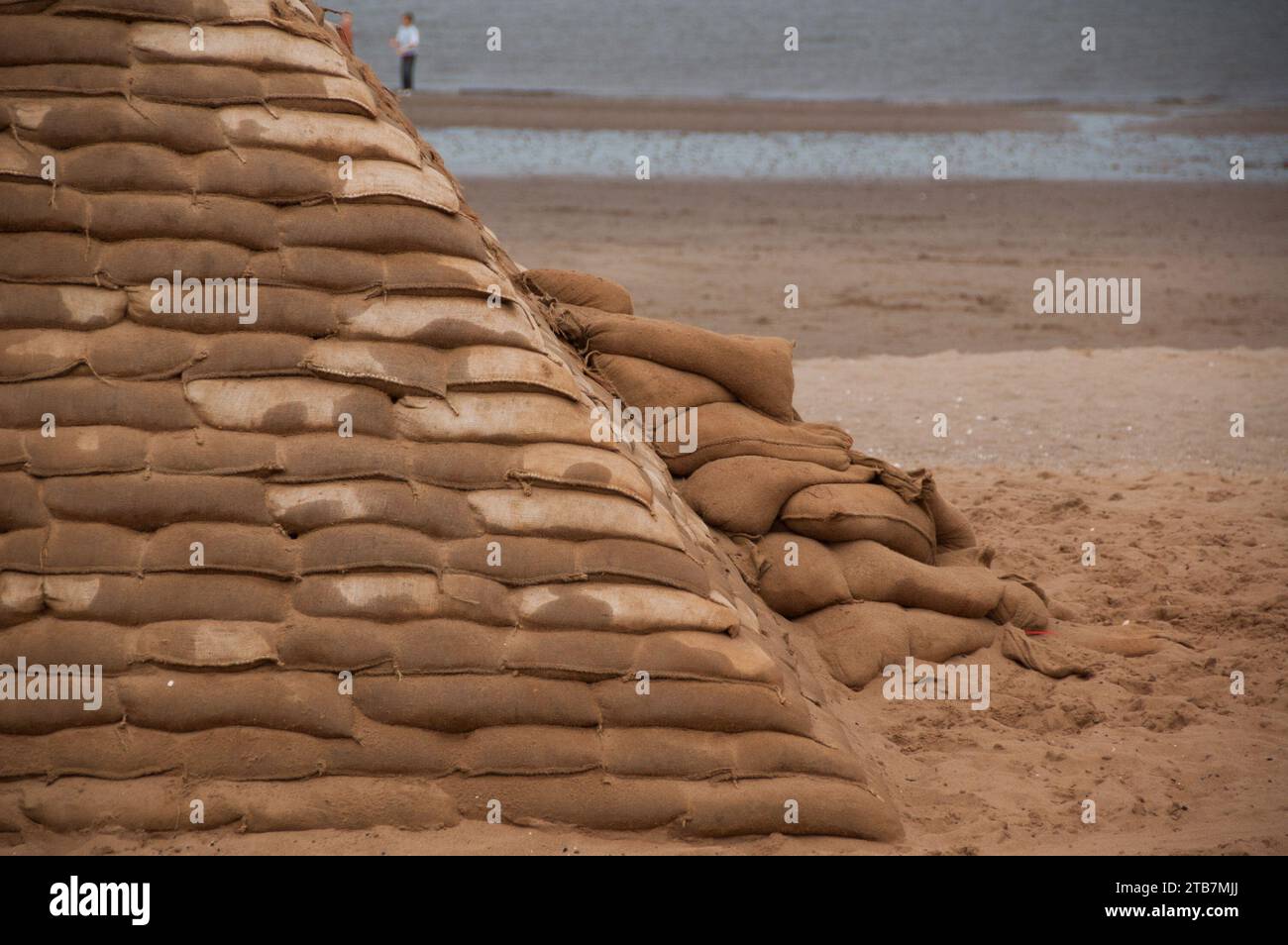 Art installation of sandbag pyramids on the beach Stock Photo Alamy