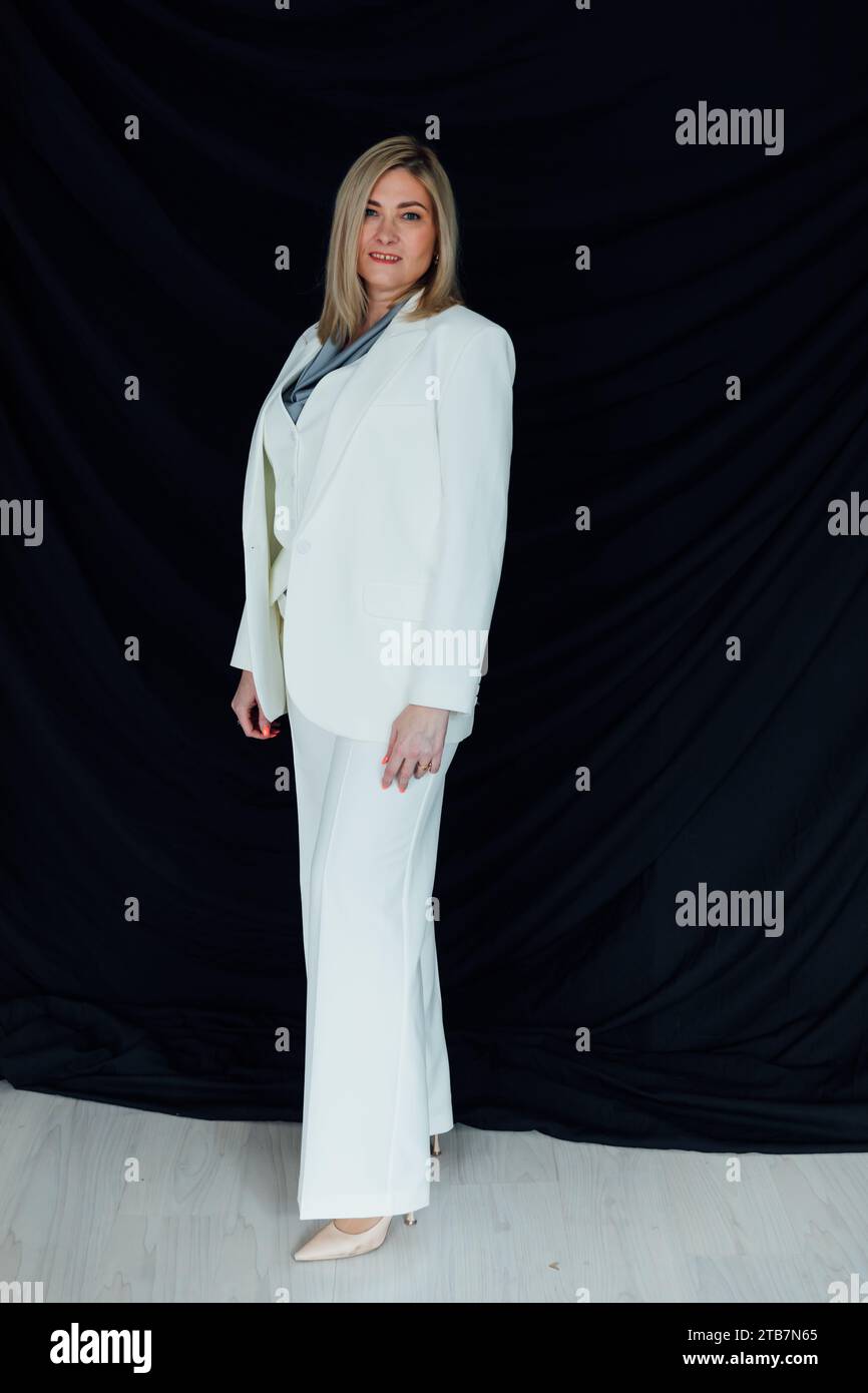 adult woman in white business suit in office Stock Photo - Alamy