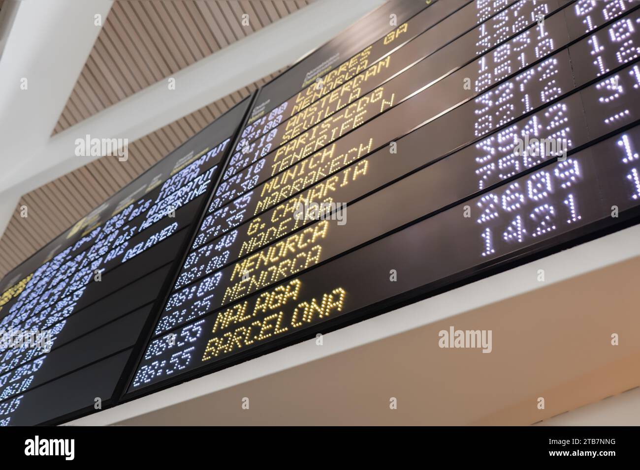 Low angle of flight schedules on digital arrival and departure board at contemporary airport Stock Photo