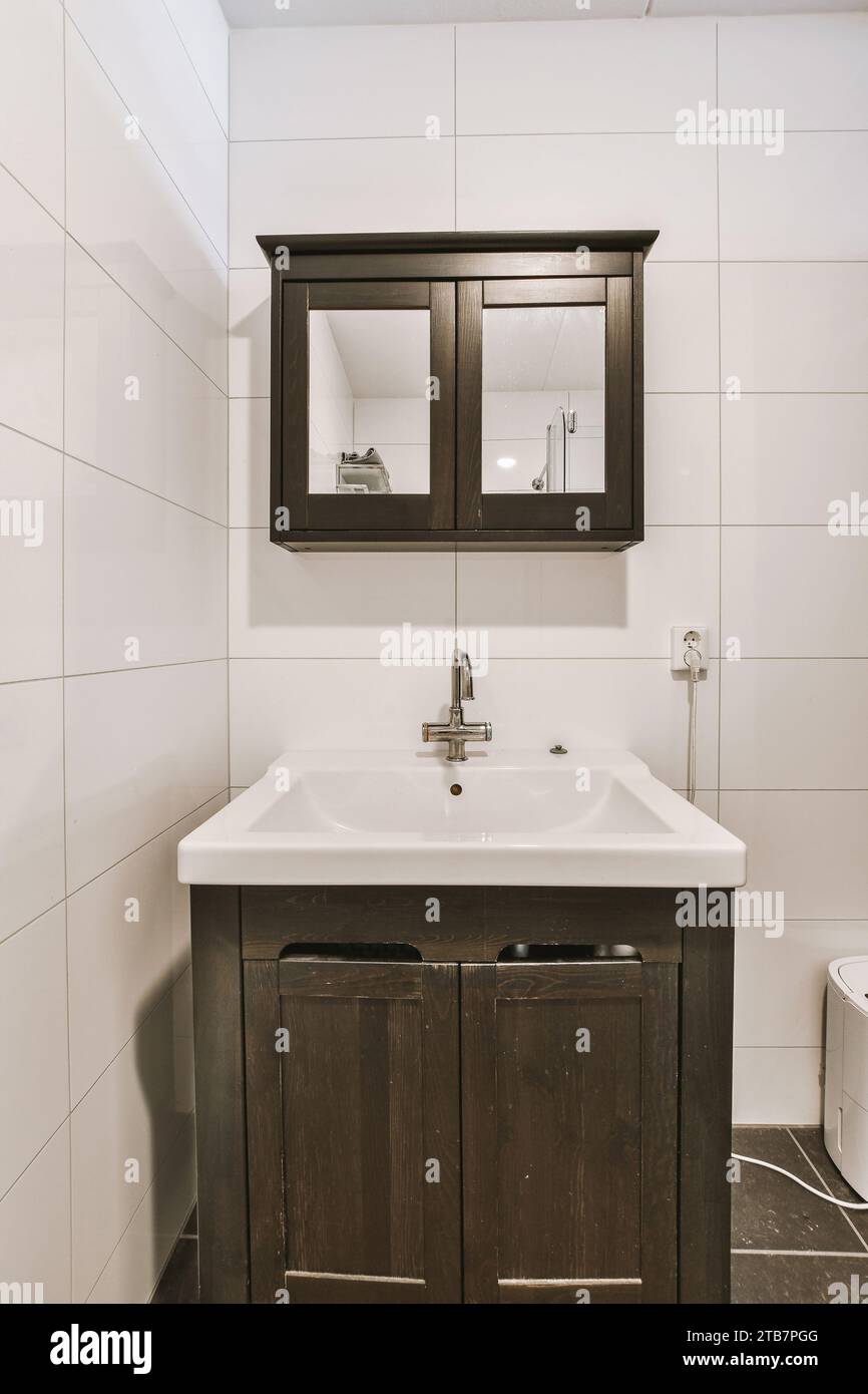 Black with mirror mounted on white tiled walls over ceramic
