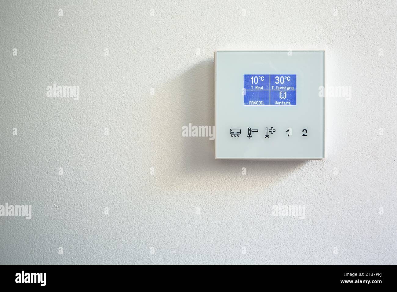 Image showcasing Closeup shot of number on screen of smart control thermostat mounted on ...