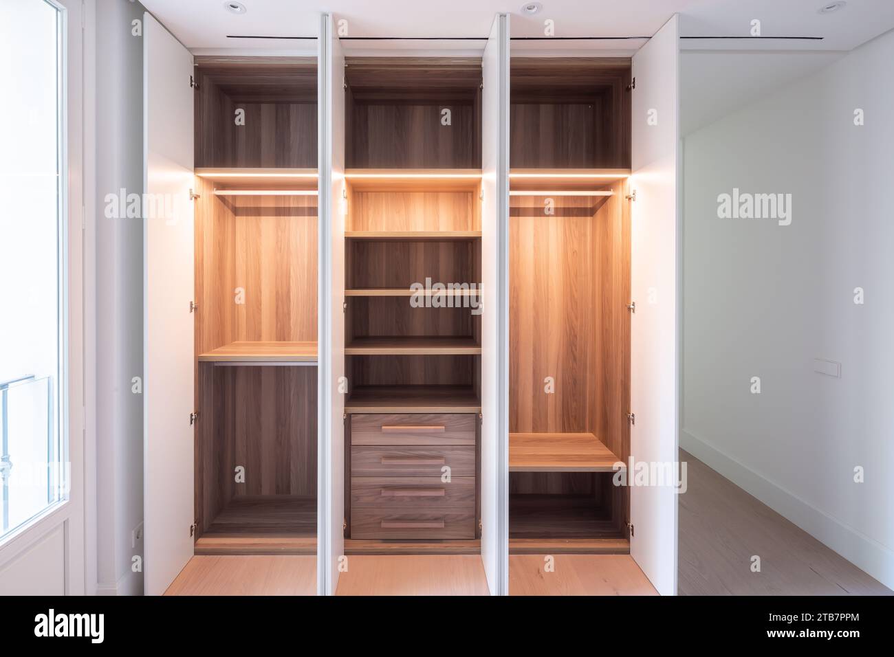 Curated visual reference: Visual Reference: Shot Of Open Empty Wooden Wardrobe With Brown And Illuminated