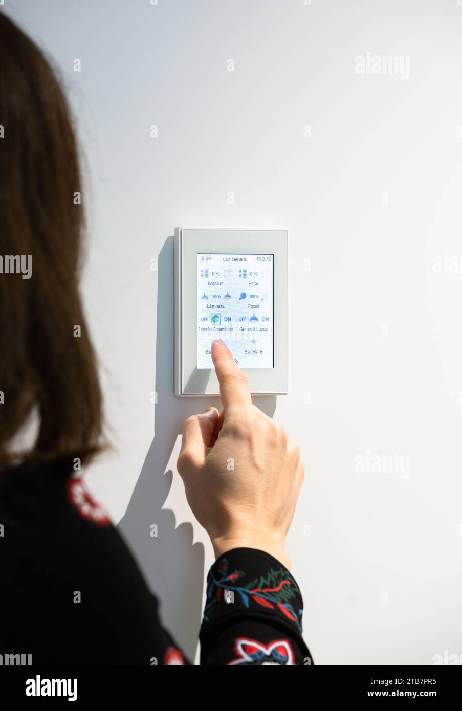 View of Crop hand of anonymous woman adjusting temperature on thermostat ...